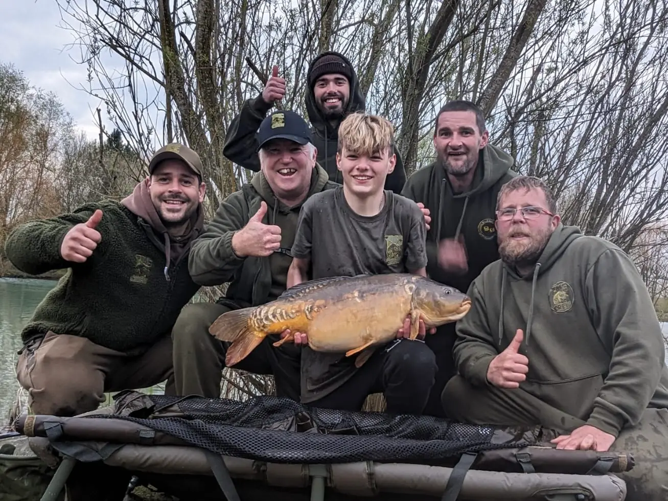 Freddy celebrates his PB carp with Gramps and the gang